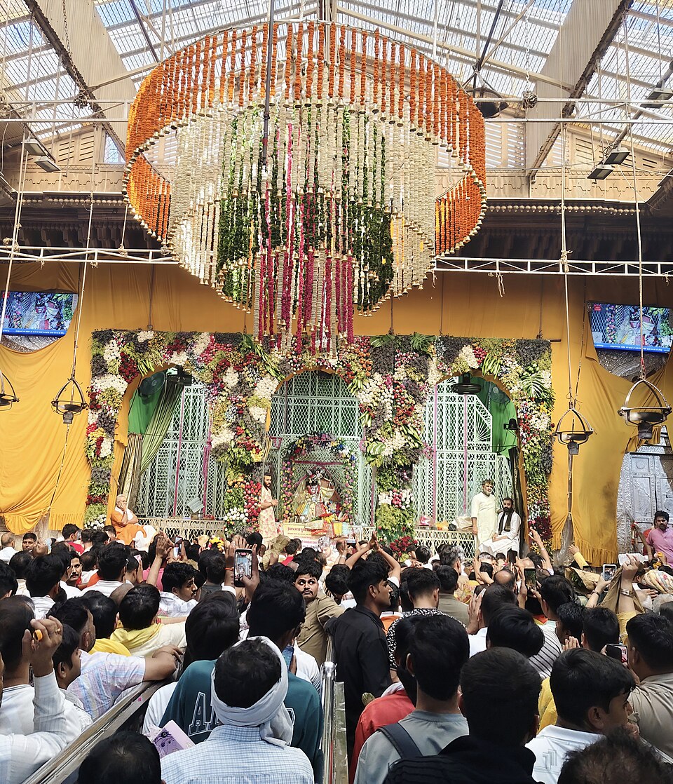 Phool bangla floral decorations above a packed darshan hall at Banke Bihari Mandir