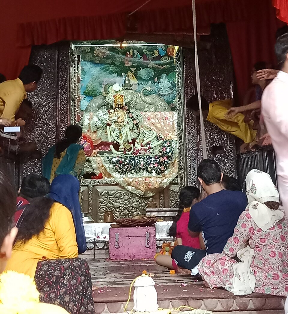 Darshan of Radha Vallabh Lal with devotees gathered before the altar